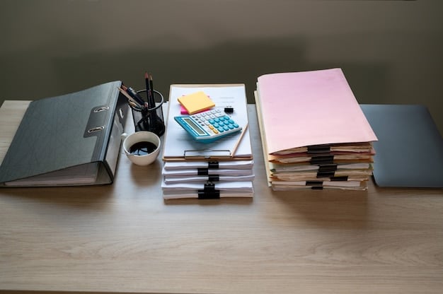 A stack of financial documents and a pen resting on a table, with a calculator and a miniature house model in the background. Focus is on the documents, suggesting the detailed research required before choosing a mortgage.
