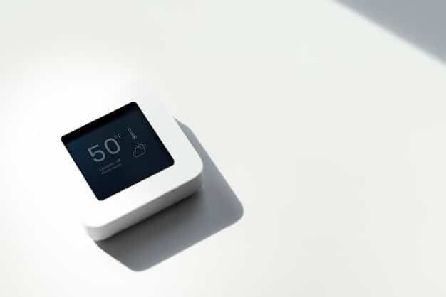A close-up shot of a smart thermostat displaying energy usage data. The thermostat is sleek and modern, and the data shows a decrease in energy consumption over time. The image embodies energy efficiency and technology working together.