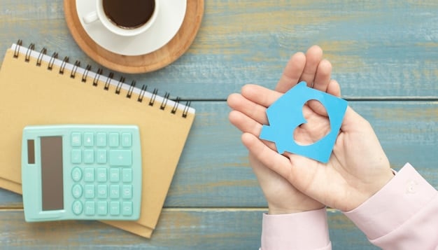 A close-up shot of a hand holding a key with a miniature house keychain, symbolizing homeownership and the mortgage application process. Calculator in the background.