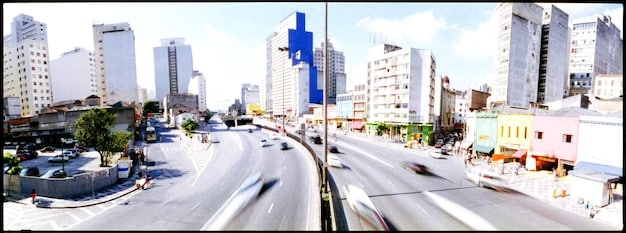 A split-screen image showing a bustling urban downtown on one side and a quiet suburban street with houses and trees on the other, visually representing the different impacts of remote work on these two types of housing markets.