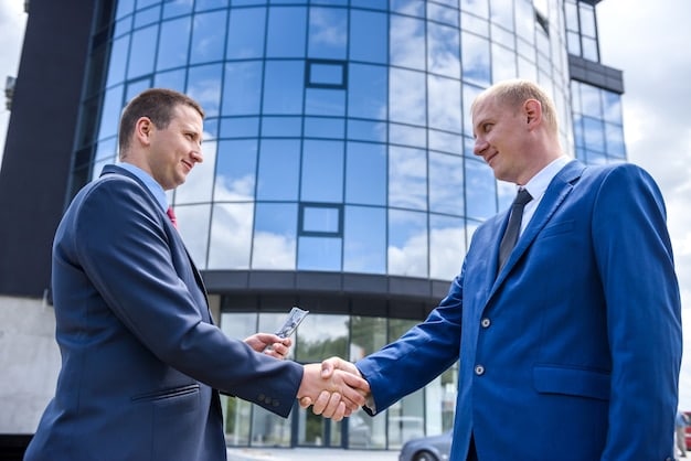 A handshake between two executives, symbolizing a formal agreement and the start of a successful strategic alliance.