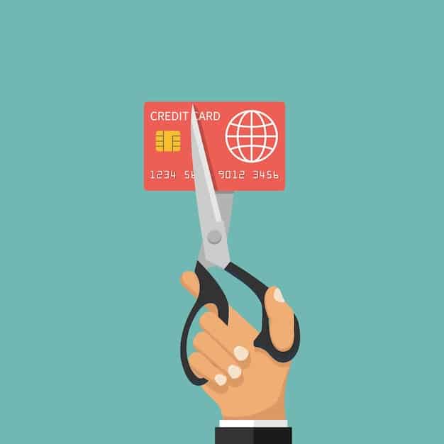 A person cutting up a credit card with scissors, symbolizing taking control of credit card debt.