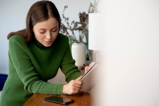 A person sitting at a desk, using a calculator to manually list their expenses to understand how much they need in an emergency fund.