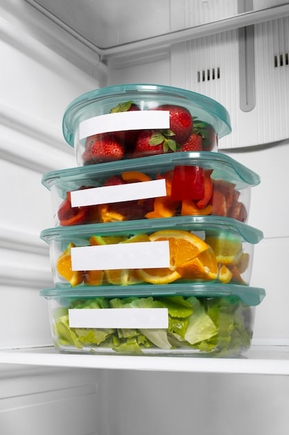 A refrigerator interior, neatly organized with transparent containers filled with labeled leftovers. Various fruits and vegetables are stored in crisper drawers, and condiments are neatly arranged on the door shelves.