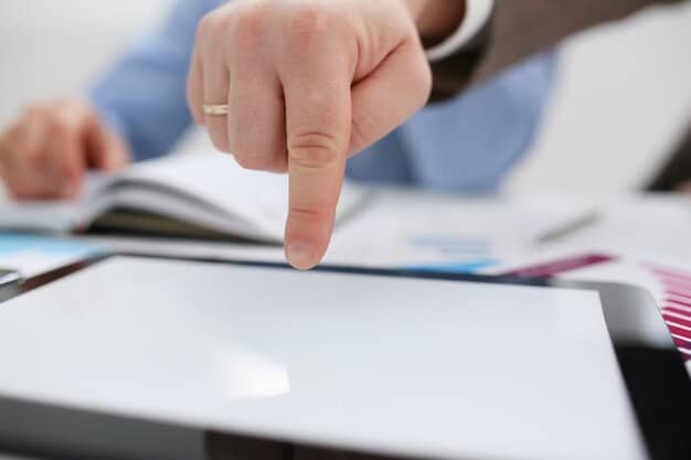 A close-up of a hand pointing at a specific entry on a credit report on a computer screen, with a magnifying glass hovering nearby to emphasize the act of reviewing details. The light from the screen illuminates the hand and magnifying glass, creating a focused and investigative atmosphere.