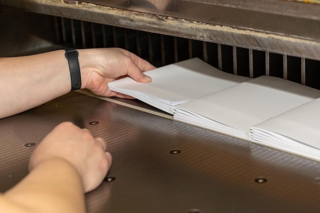 A person carefully shredding a document containing a Social Security number, with a focus on the shredder and the pieces of paper.
