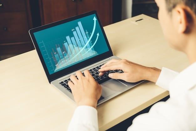 A person using a laptop with a graph showing steady growth of investment returns. The focus is on the screen, displaying positive financial trends, with the person's hands typing on the keyboard. The setting is a bright, modern office space.