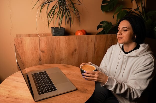 A person sitting comfortably on their couch, using a laptop with a cup of coffee on the table. The room is softly lit, and the individual appears relaxed and focused on their work.