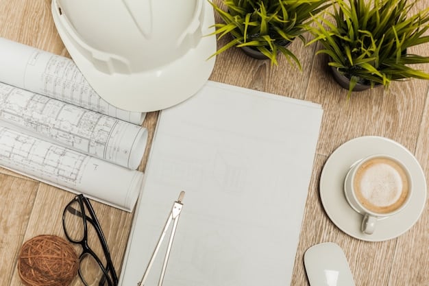 Close-up of architectural blueprints spread out on a table, with a hard hat and safety glasses resting on top. A pencil points to a specific detail on the plans, conveying precision and planning.